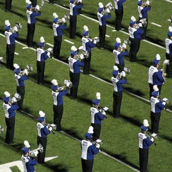 Woodwinds and brass in lines on the field
